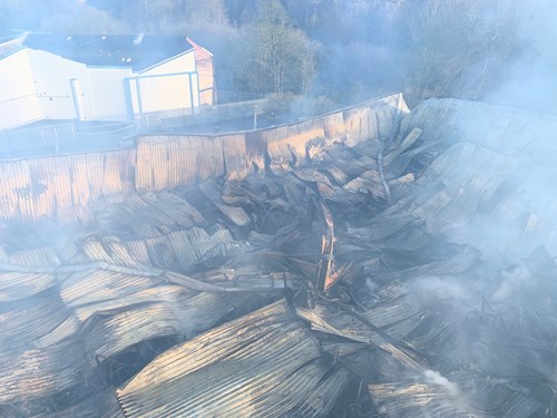 Smoke around the collapsed structure after the fire