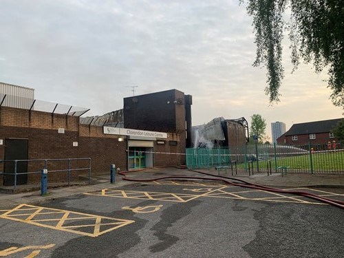 An exterior view of a large brick building damaged by fire