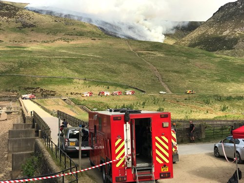 Fire Service vehicles on the scene of the wildfire above Dove Stone Reservoir