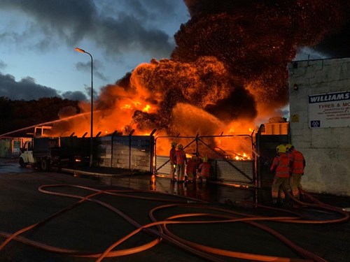 Photograph of firefighters putting out the fire at the industrial yard in Ince