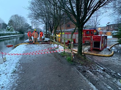 A picture of firefighters and fire engines at the scene of the fire in snowy conditions