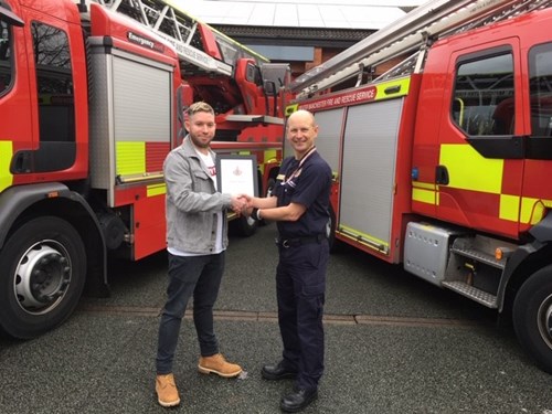 GMFRS volunteer receives certificate from Station Manager Wilson