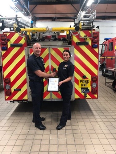 Watch Manager John Morris presents firefighter Sarah Beever-Nuttall with her certificate