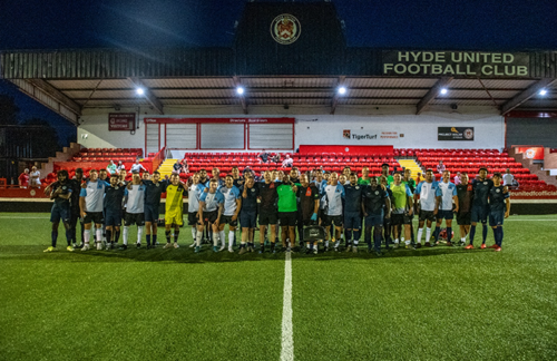 Both football teams together at Hyde United Football Club.