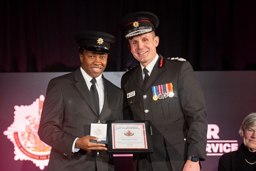 Firefighter, Mbekezeli Moyo receiving his Chief Fire Officer’s Commendation from Chief Fire Officer, Dave Russel.
