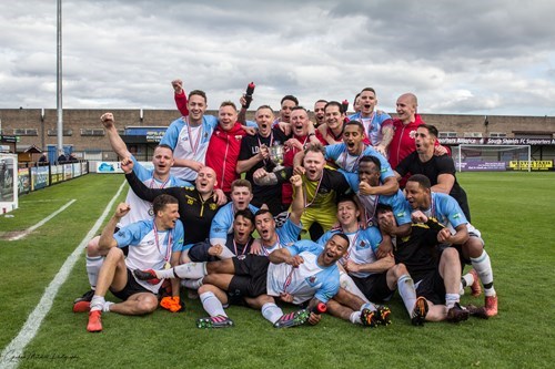 mens football section celebrating on football pitch.