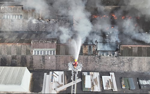 An aerial image of firefighters tackling a fire at a commercial unit