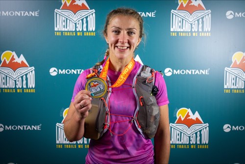 Sophie Pilkington stood wearing running clothes with a medal.
